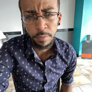 a man with glasses and a blue shirt