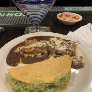 Guacamole taco and cheese and onion enchilada