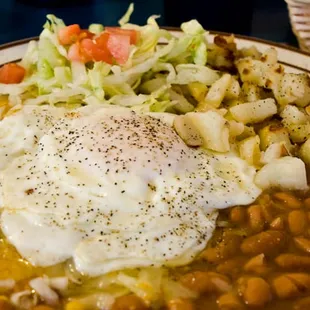 From a few years ago, Huevos Rancheros, over easy, with green chile.