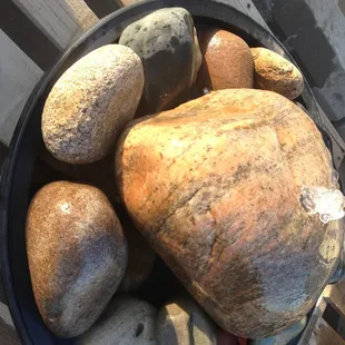 a bowl of rocks on a bench