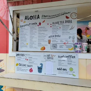 a menu on the wall of a coffee shop