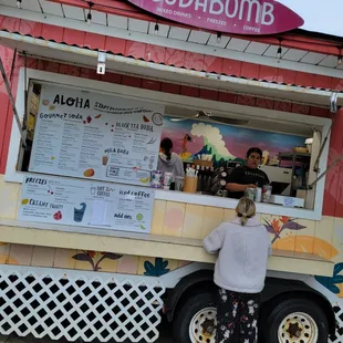 a woman ordering from a food truck
