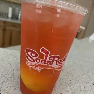 a drink in a plastic cup on a counter