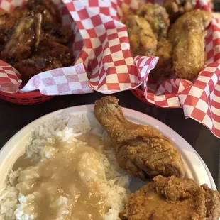 Daily special plate with 2 pieces, rice and gravy and Asian and Parmesan fried wings.