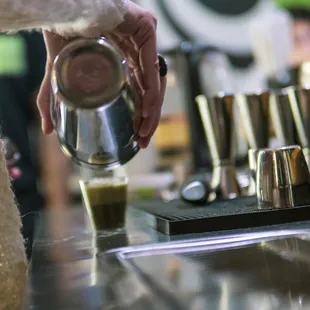 a person pouring a drink