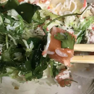 Crab salad, seaweed salad, salmon, white rice/greens, cilantro, Cucumber.