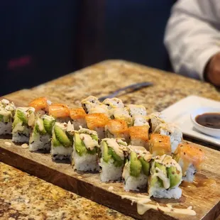 a sushi on a cutting board