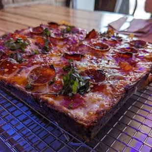 a pizza on a cooling rack