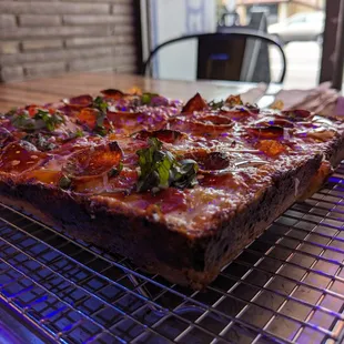 a pizza on a cooling rack
