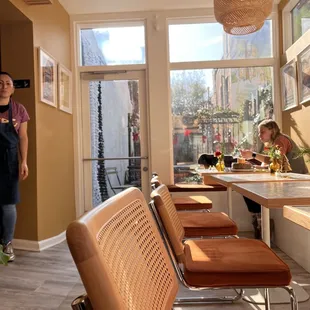 a woman standing at a counter in a restaurant