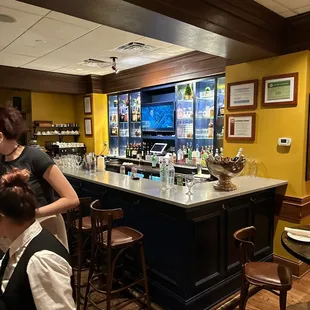 a bar with people sitting at it