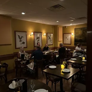 people sitting at tables in a restaurant