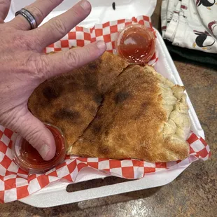 Sophia&apos;s calzone. Huge!! My hand to compare the size!!