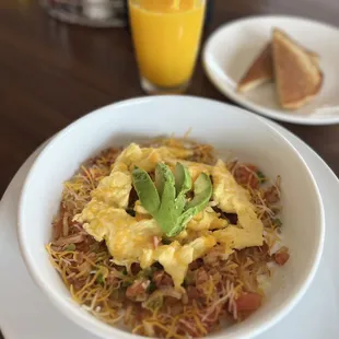 a plate of food and a glass of orange juice
