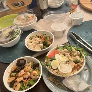 a table with bowls of food and utensils