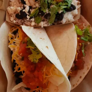 Black bean tacos, with a side of rice and beans.