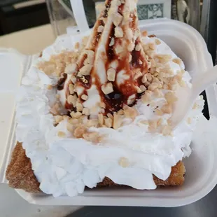 These are churros, soft serve vanilla ice cream w/ whip cream, and chocolate syrup with nuts:)