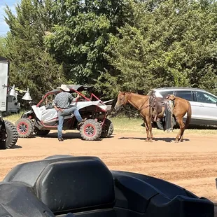 Cowboy talking to a guy in a sxs