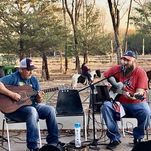 two men playing guitar