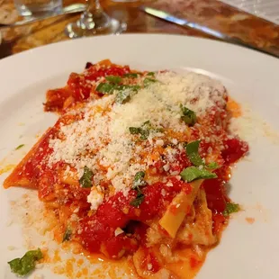 a plate of pasta with sauce and parmesan cheese