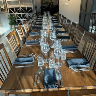 a long wooden table with place settings