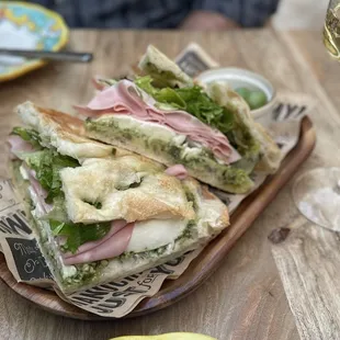 Bolognese schiacciate! Mortadella, mozzarella, pesto. Fresh and so tasty! Gavi de gavi wine from piedmont region of Italy.
