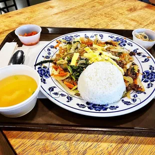 a plate of rice and a bowl of soup