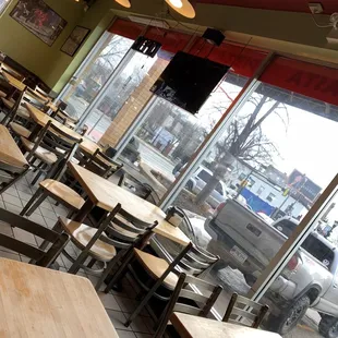 tables and chairs in front of a window