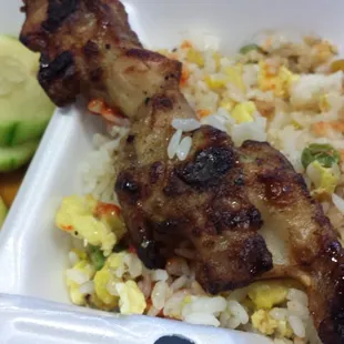 Garlic fried rice (already a bit spicy), baked chicken skewer and cucumber salad.