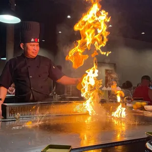 a chef cooking a fire