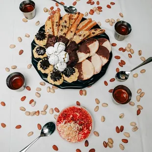 a platter of cookies, crackers, and dips