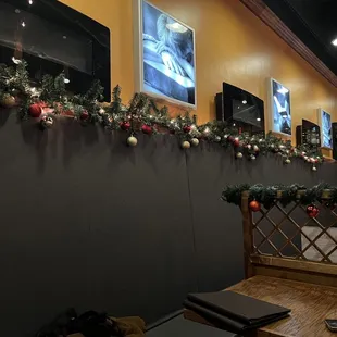 a bar with christmas decorations on the wall