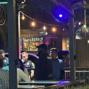 a group of people sitting outside at a bar