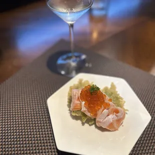 a plate of sushi and a glass of wine