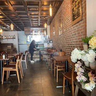 a woman sitting at a table in a restaurant