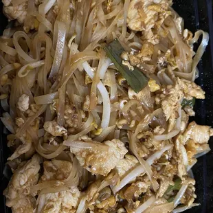 chicken and noodles in a black container