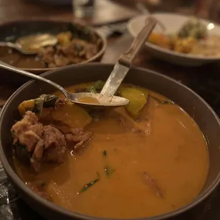 a bowl of soup with a spoon