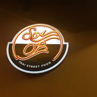 a neon sign for a thai street food restaurant