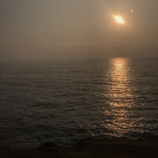 the sun setting over the ocean