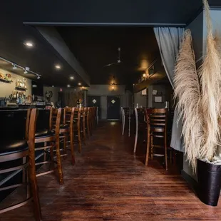 a bar with wooden tables and chairs