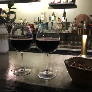 two glasses of wine on the bar
