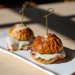 Brunch Menu: Pretzel bun sliders - House made pretzel bun; ham and swiss, garlic aioli