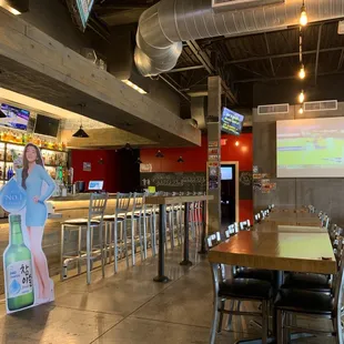 a woman standing in front of a bar