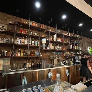 a woman standing at a bar