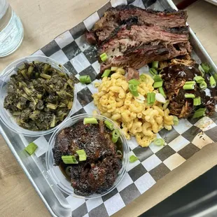 Callaloo (greens), smoked oxtail, mac and cheese, smoked jerk chicken, and smoked prime brisket