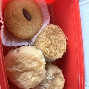 a variety of pastries in a plastic container