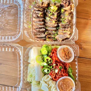 two take out containers of food