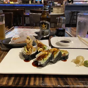 a plate of sushi and a glass of beer