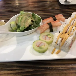a plate of sushi and a salad