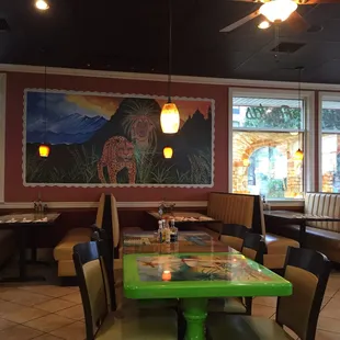 a dining area with tables and chairs
